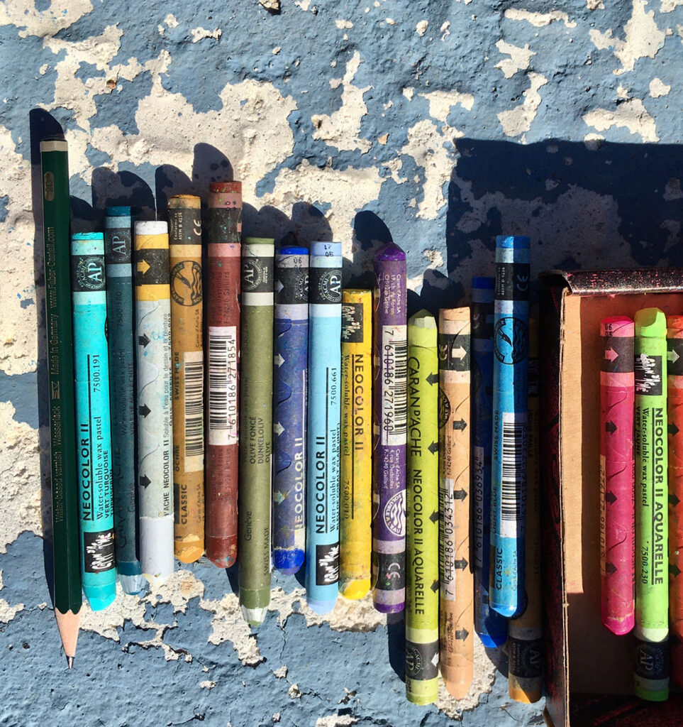 Drawing tools on a sunlit stone wall, symbolising outdoor sketching with Lighthouse Artcourses in the Algarve