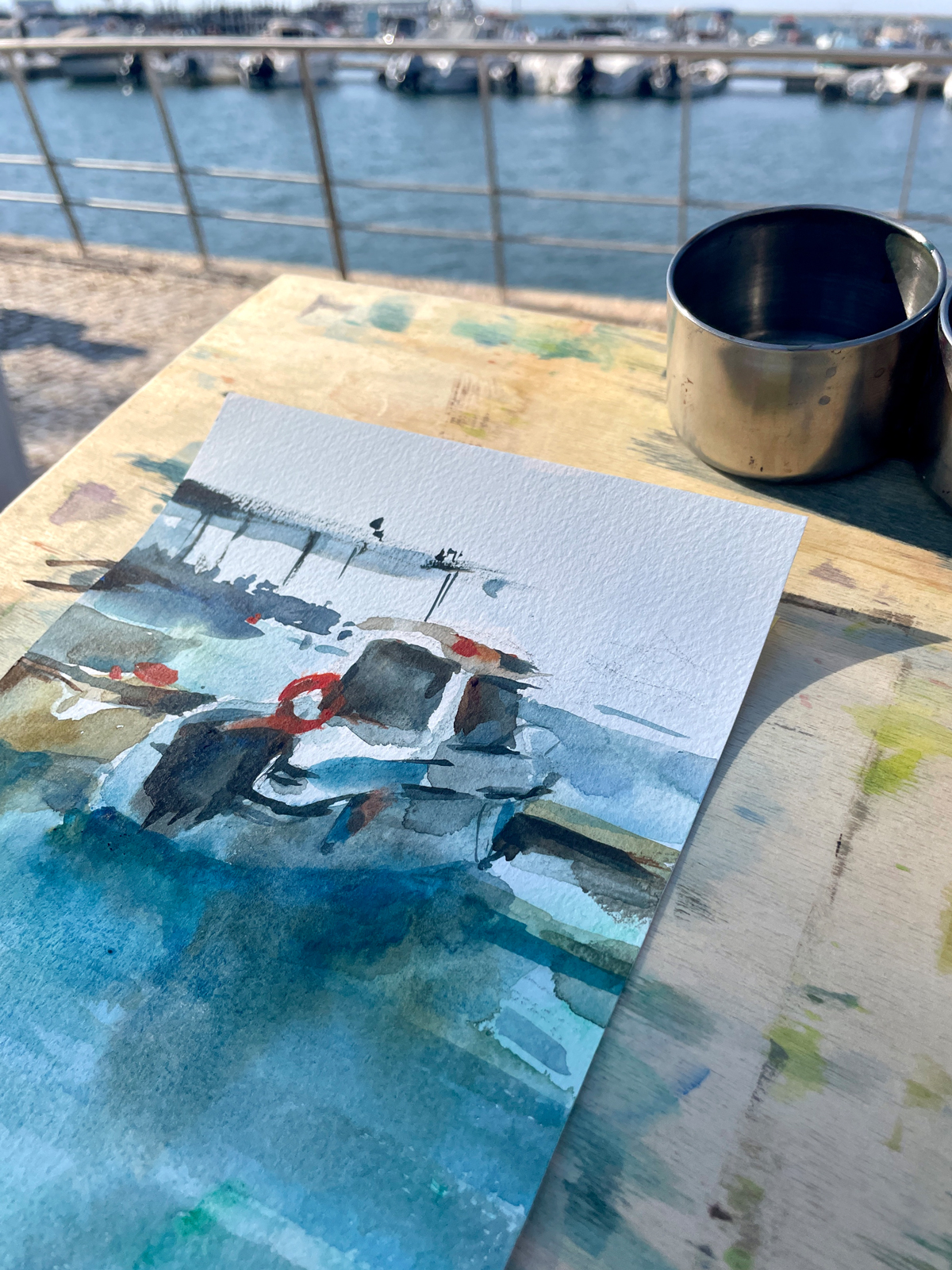 Watercolor sketch of a small private boat (barca) in Olhão, painted outdoors in a plein air setting.