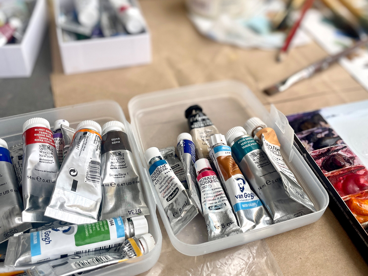 Facade of an old house in Olhão with tall windows and decorative Art Nouveau-style doors, now home to a Domino's restaurant