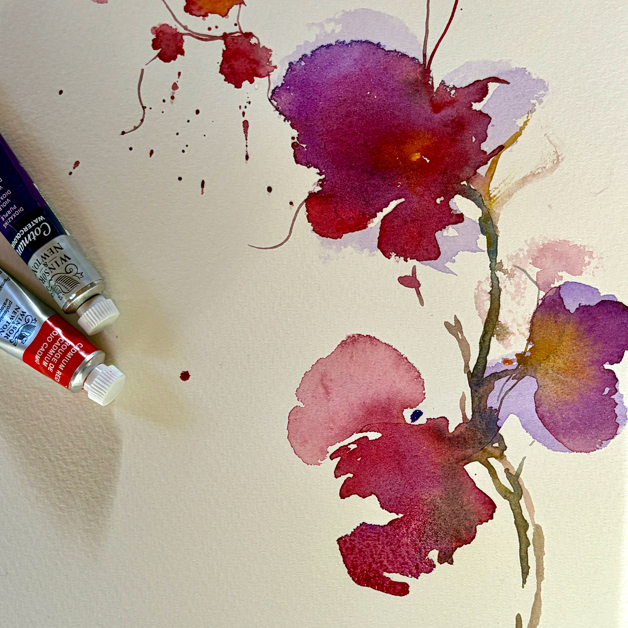 Close-up of a watercolor palette with half-mixed colours, showing the painting process for the Watercolour Winter Weekends course.