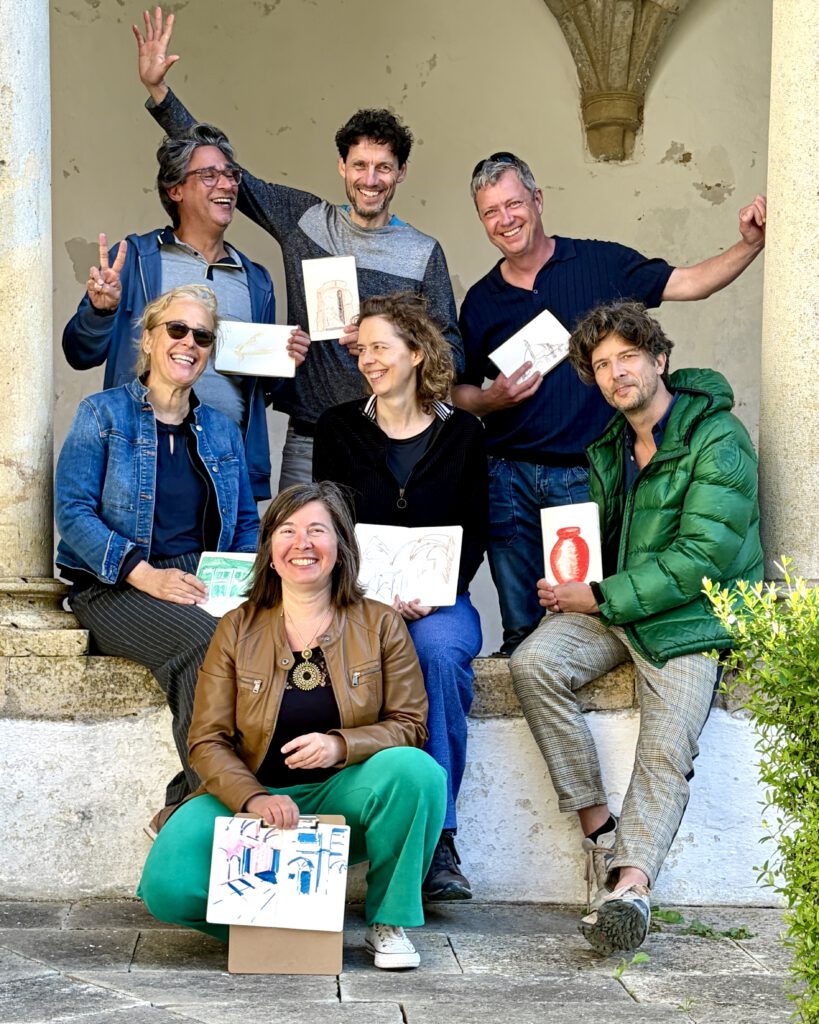 Happy group of artists showing sketchbooks after a Faro Sketchwalk creative experience in Algarve, combining sketching, watercolour and place-based observation